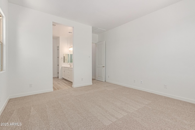 21952 E Saddle Ct E, Queen Creek, AZ 85142 - unfurnished bedroom featuring light colored carpet, baseboards, and connected bathroom