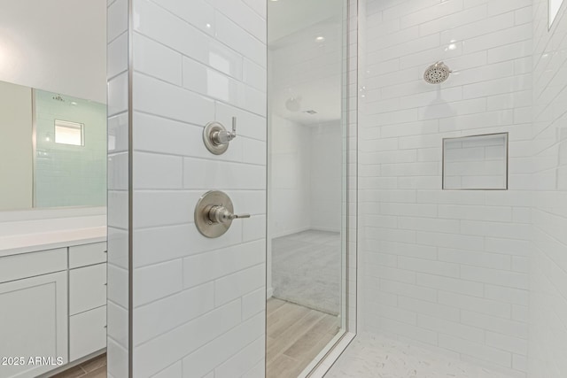 21952 E Saddle Ct E, Queen Creek, AZ 85142 - bathroom featuring tiled shower, vanity, and wood finished floors