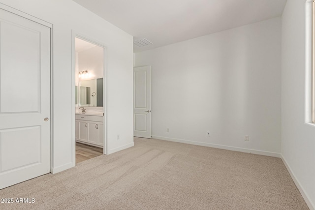 21952 E Saddle Ct E, Queen Creek, AZ 85142 - unfurnished bedroom featuring light carpet, baseboards, and connected bathroom