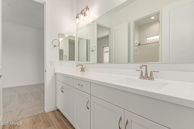 21952 E Saddle Ct E, Queen Creek, AZ 85142 - full bathroom with double vanity, baseboards, and wood finished floors