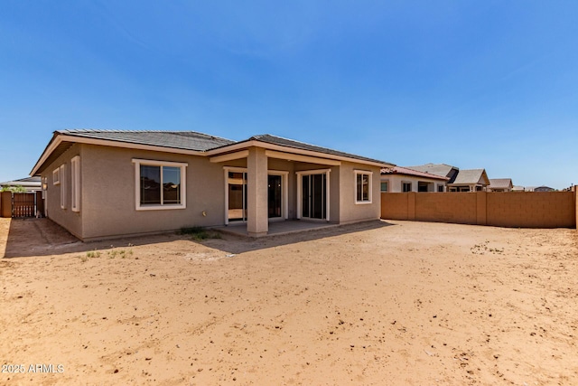 21952 E Saddle Ct E, Queen Creek, AZ 85142 - rear view of property featuring a fenced backyard, stucco siding, a patio, and a tile roof