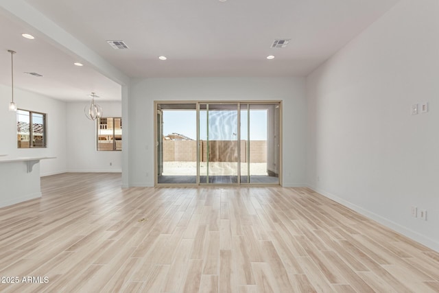 21952 E Saddle Ct E, Queen Creek, AZ 85142 - unfurnished living room with light wood finished floors, recessed lighting, a chandelier, and baseboards