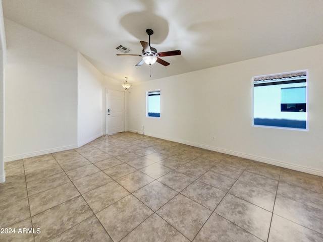 unfurnished room with light tile patterned flooring and ceiling fan