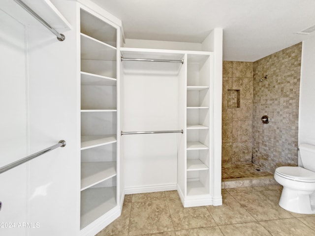 spacious closet with light tile patterned floors