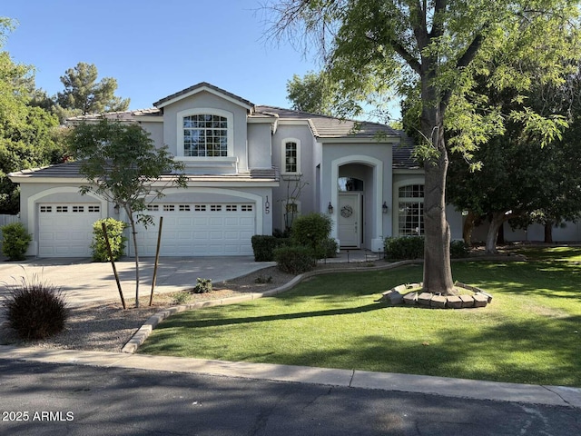 view of front of home with a tiled roof, stucco siding, a front lawn, a garage, and concrete driveway