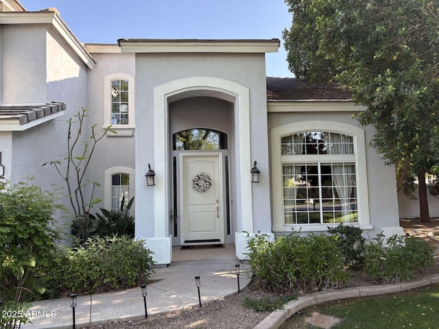 property entrance featuring stucco siding