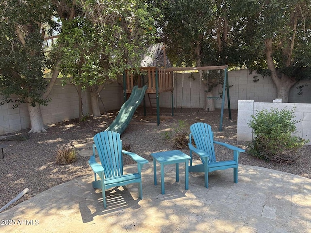 view of patio featuring a fenced backyard and a playground
