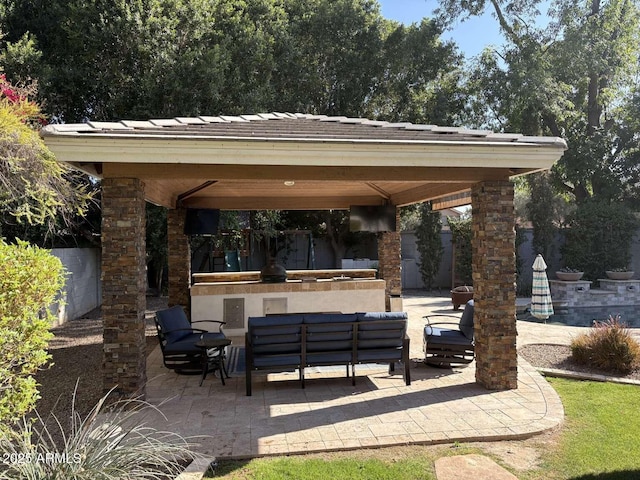 view of patio with outdoor lounge area and a gazebo