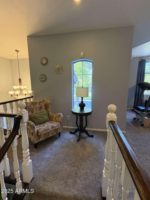 living room with a chandelier, carpet flooring, and baseboards