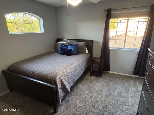 carpeted bedroom featuring baseboards and a ceiling fan