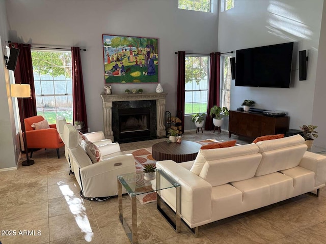 living room featuring a towering ceiling and a premium fireplace