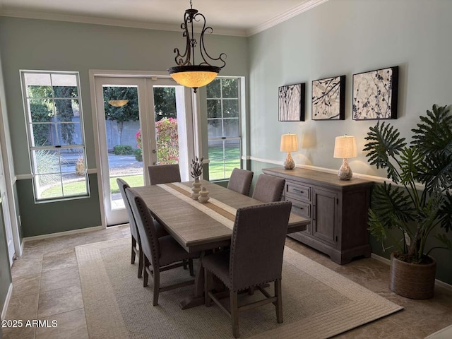 dining space featuring crown molding, french doors, baseboards, and a wealth of natural light