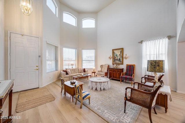 living room featuring a wealth of natural light, baseboards, and light wood-style floors