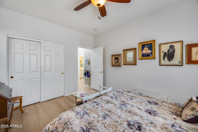 bedroom with a closet, light wood finished floors, and ceiling fan