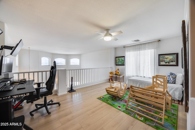 office with visible vents, ceiling fan, and wood finished floors