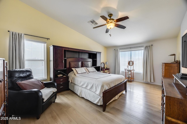 bedroom with lofted ceiling, light wood-style floors, visible vents, and ceiling fan