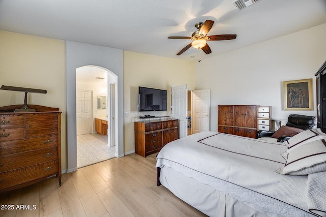 bedroom with visible vents, ceiling fan, baseboards, light wood-style floors, and arched walkways