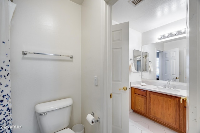 full bath featuring tile patterned flooring, visible vents, toilet, and vanity