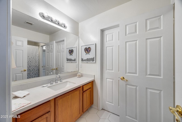 bathroom featuring visible vents, vanity, and tile patterned flooring