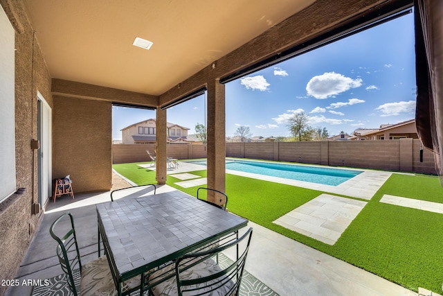 view of patio / terrace featuring outdoor dining area, a fenced backyard, and a fenced in pool