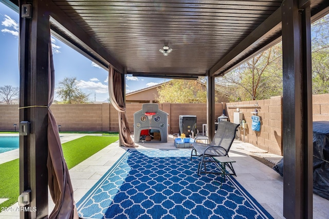 view of patio / terrace featuring a fenced backyard and a fenced in pool