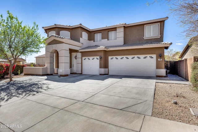 view of front of house featuring concrete driveway, a tiled roof, a garage, and stucco siding