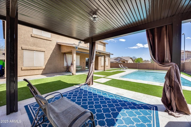 view of swimming pool featuring a fenced in pool, a yard, a fenced backyard, and a patio area