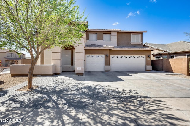 view of front of home featuring fence, driveway, stucco siding, a garage, and a tiled roof