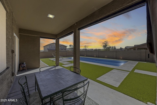 view of patio / terrace with a fenced in pool, outdoor dining area, and a fenced backyard