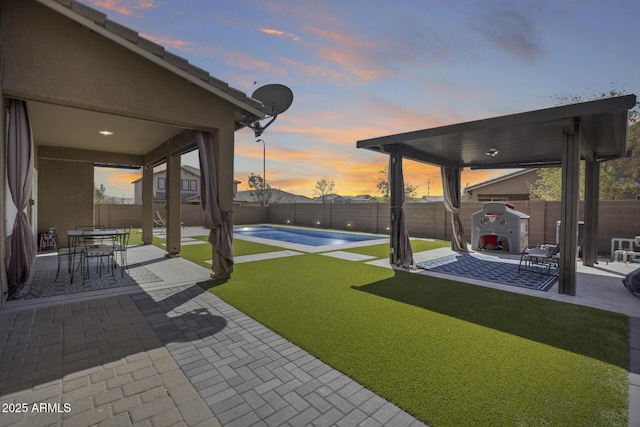 view of yard with a fenced in pool, a fenced backyard, and a patio area