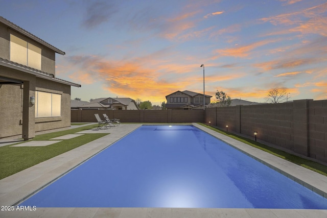 view of swimming pool featuring a patio, a fenced backyard, and a fenced in pool