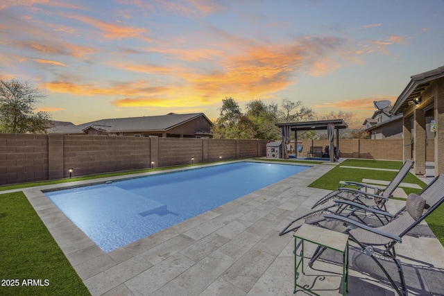 view of swimming pool featuring a patio area, a yard, a fenced backyard, and a fenced in pool