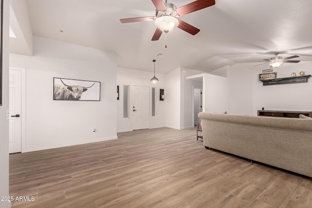 living room featuring ceiling fan, wood-type flooring, and lofted ceiling