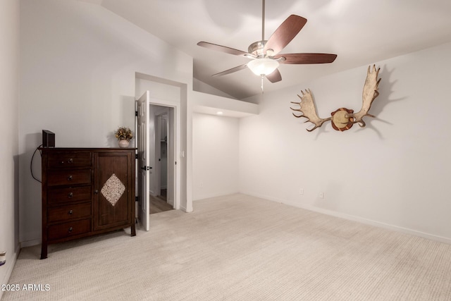 bedroom with ceiling fan, light carpet, and vaulted ceiling