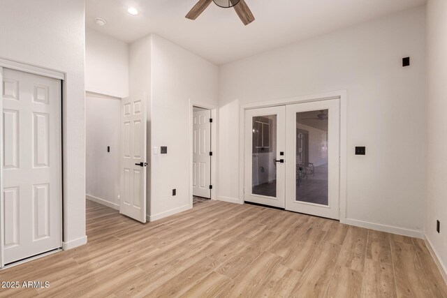 spare room with ceiling fan, french doors, and light hardwood / wood-style flooring