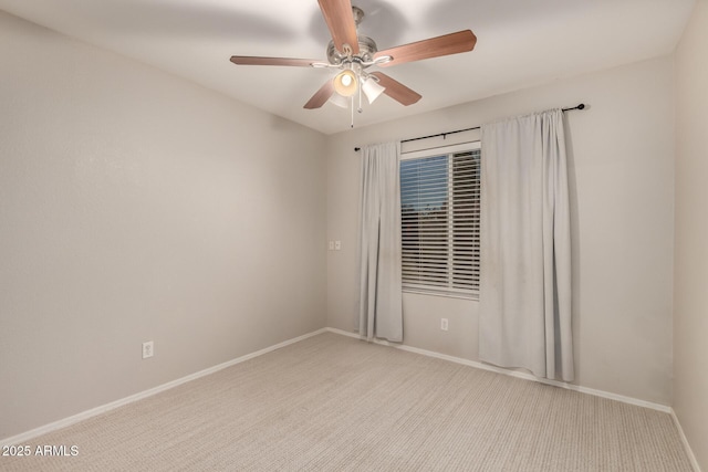 spare room with light carpet and ceiling fan