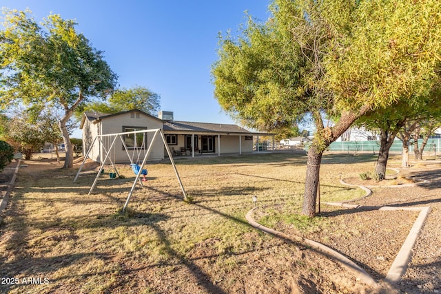 back of house with a lawn