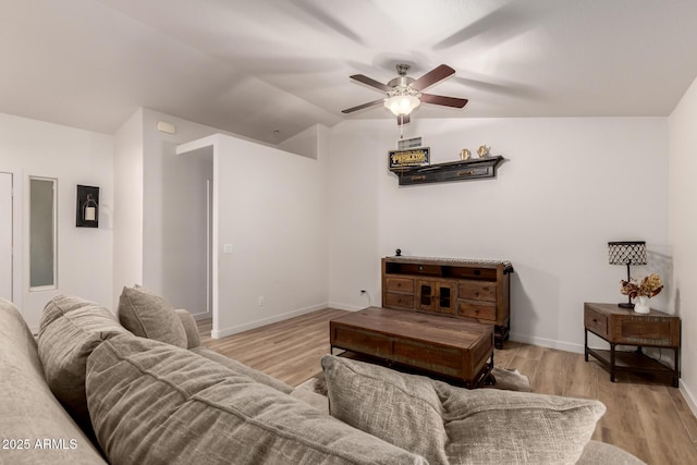 living room featuring light hardwood / wood-style floors, ceiling fan, and lofted ceiling