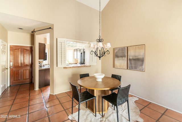 tiled dining area with lofted ceiling and a chandelier