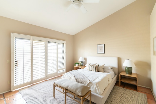 bedroom featuring ceiling fan, tile patterned floors, and lofted ceiling