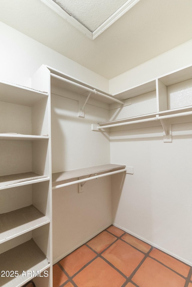 spacious closet with tile patterned floors