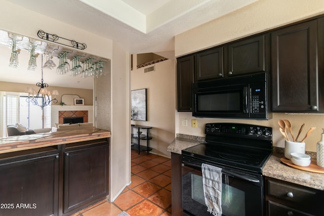 kitchen featuring dark brown cabinets, light tile patterned floors, and black appliances