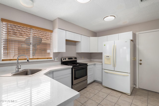 kitchen featuring light countertops, a sink, white refrigerator with ice dispenser, white cabinetry, and electric range