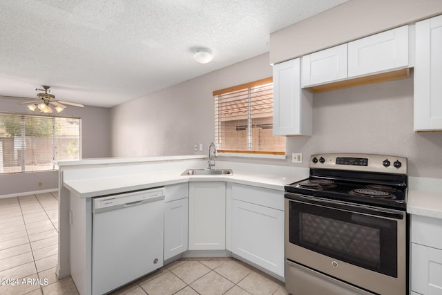 kitchen with light countertops, a sink, stainless steel range with electric stovetop, a peninsula, and white dishwasher