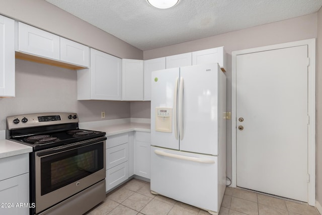 kitchen featuring a textured ceiling, light countertops, white cabinets, white fridge with ice dispenser, and electric stove