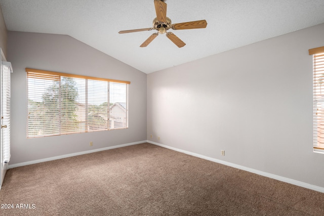 unfurnished room with carpet floors, a textured ceiling, vaulted ceiling, and ceiling fan