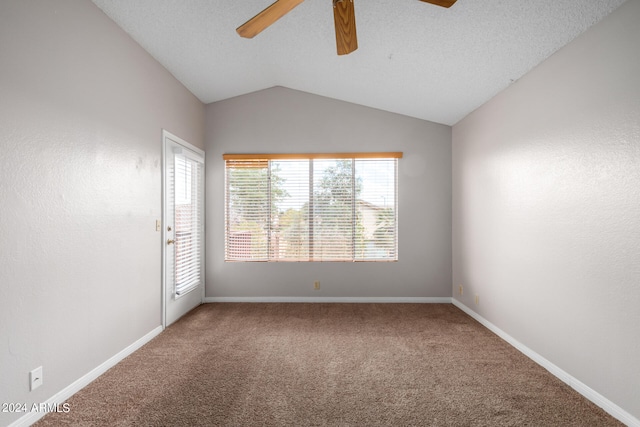 unfurnished room featuring a textured ceiling, carpet flooring, vaulted ceiling, and ceiling fan