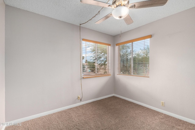 unfurnished room featuring a ceiling fan, carpet, baseboards, and a textured ceiling
