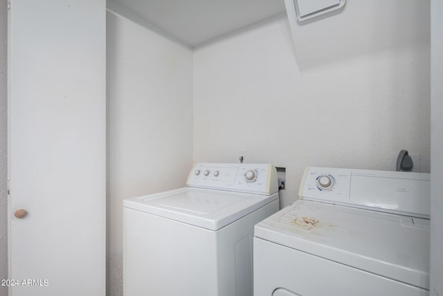 clothes washing area featuring laundry area and washer and clothes dryer