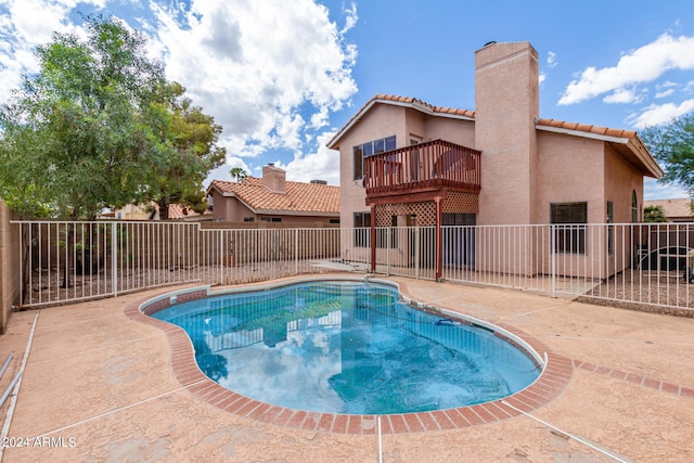view of swimming pool with a patio area, fence, and a fenced in pool